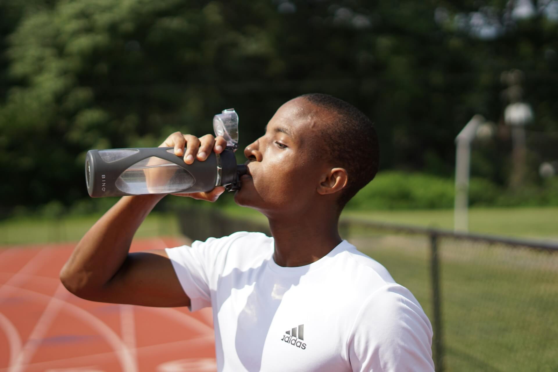 An athlete hydrating for better performance, one of the benefits of clean drinking water
