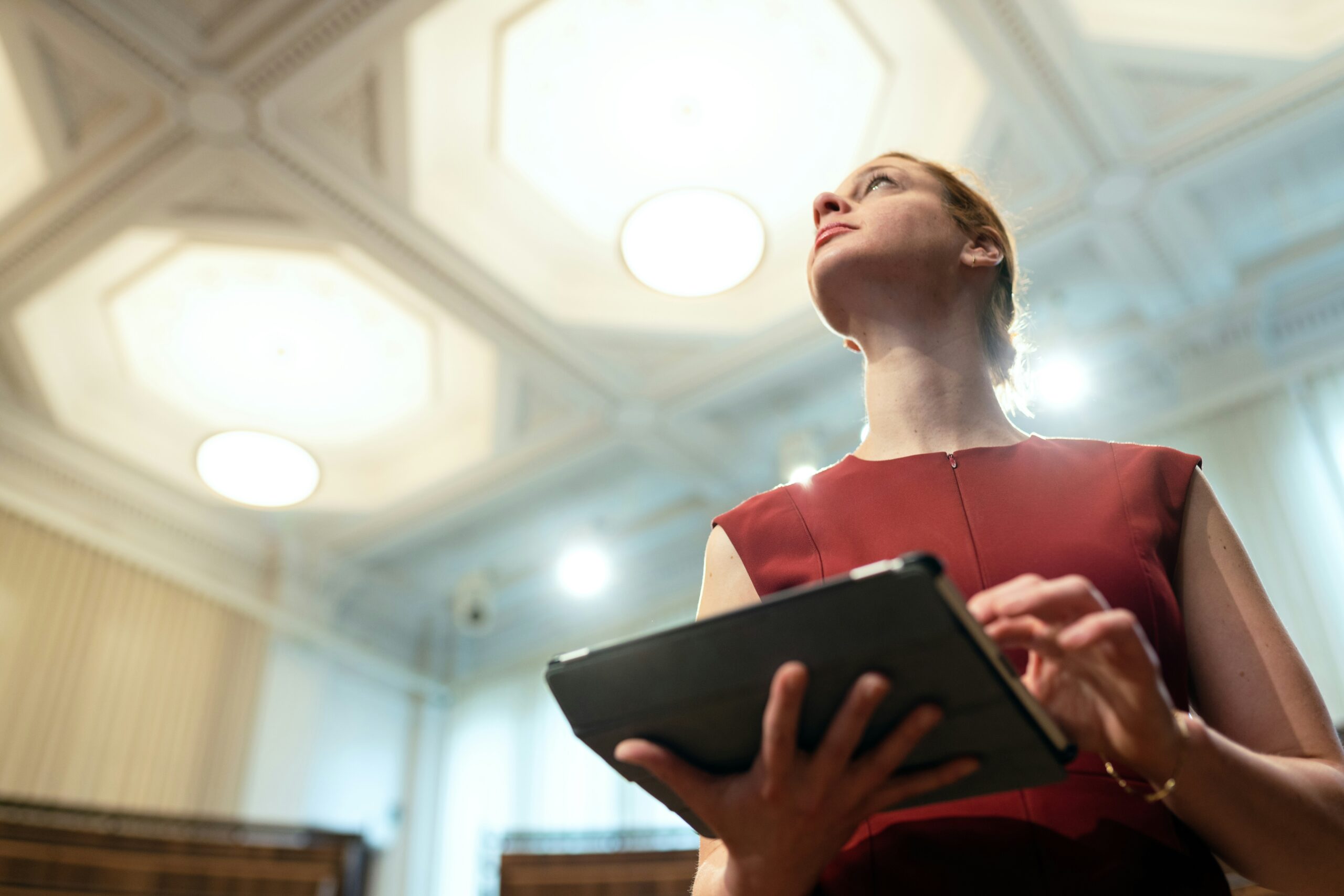 Woman looking at a brightly lit-up ceiling