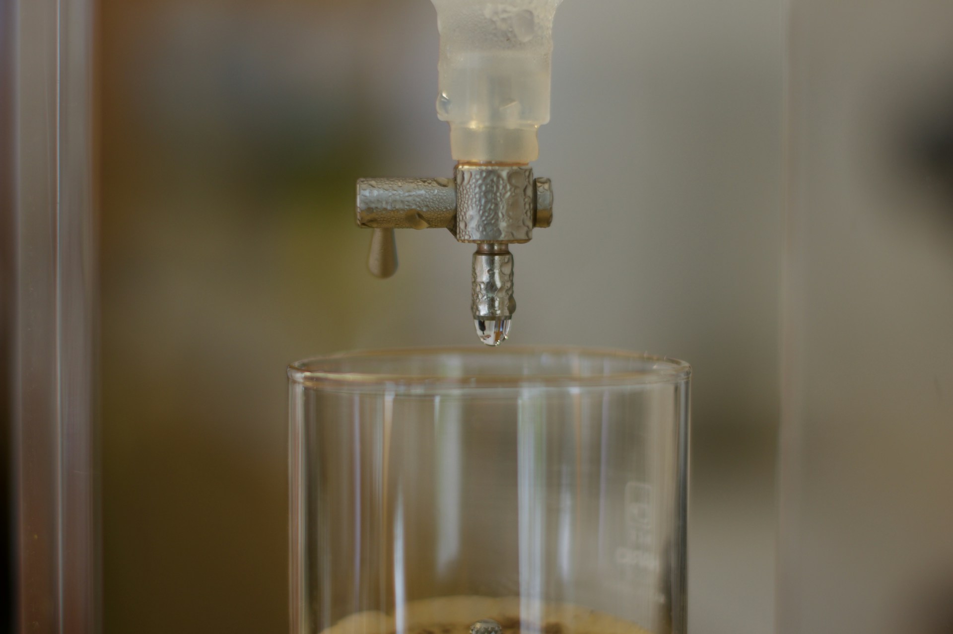 Clear glass, small tap, water droplets, cold water